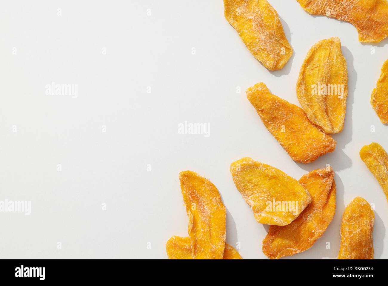 Dried mango chips on a white background Stock Photo