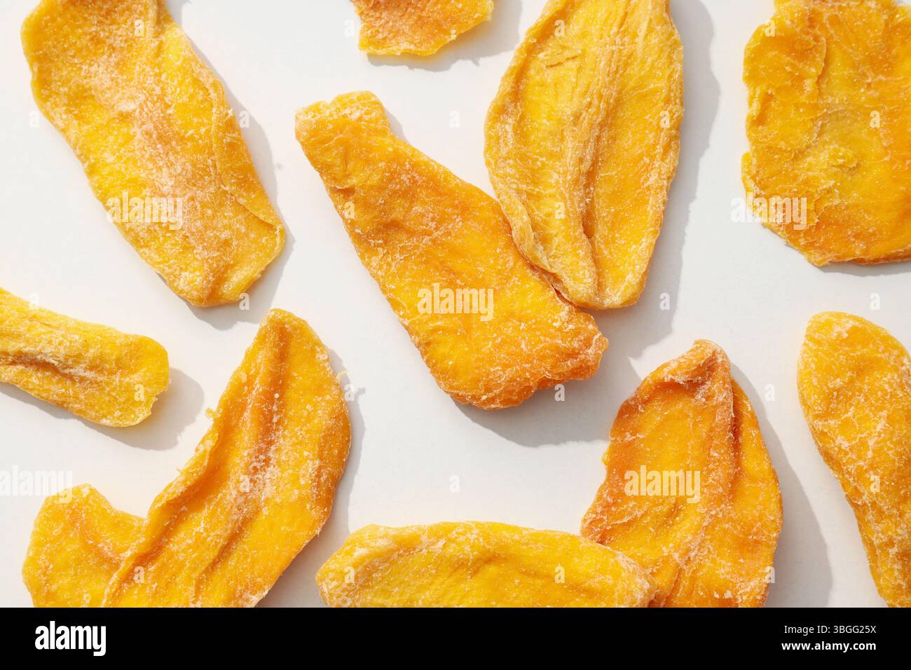 Dried mango chips on a white background Stock Photo