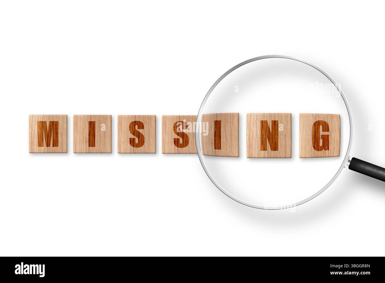 Word MISSING made of square wooden tiles. View through magnifying glass Stock Photo