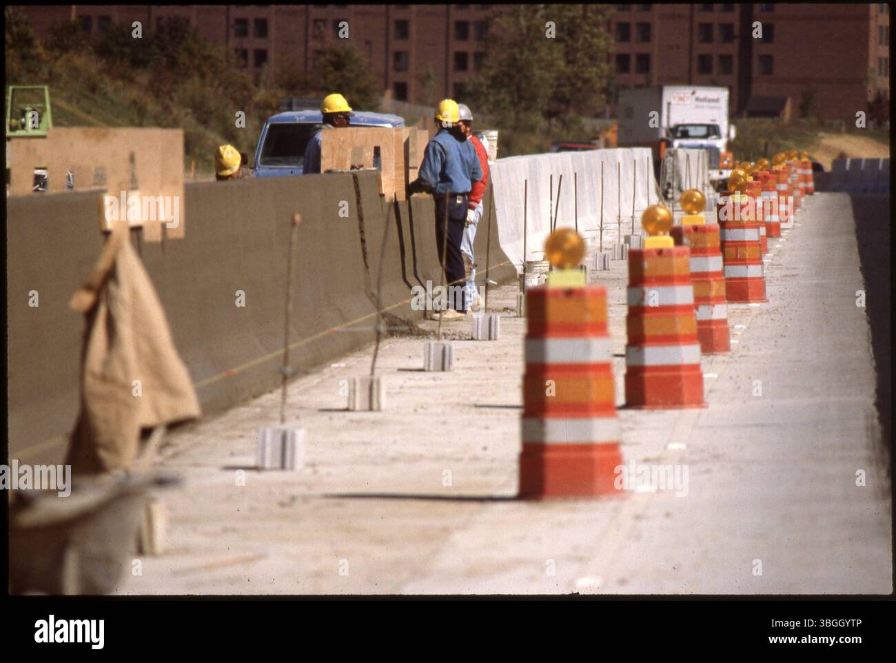 Construction workers in orange uniforms hi-res stock photography and ...