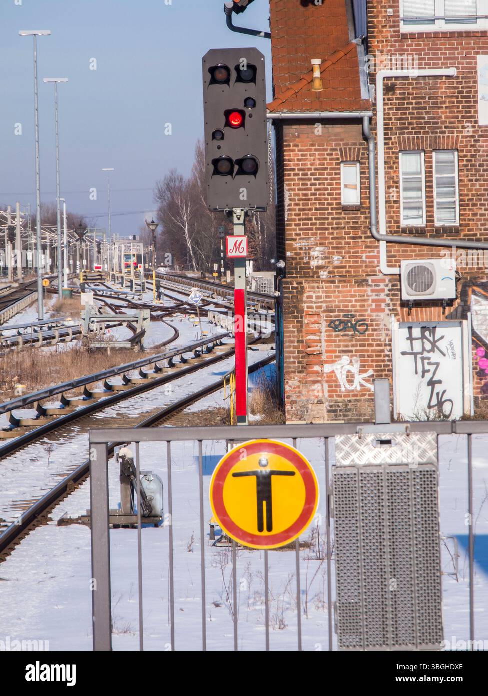 Barrier grid at the end of a platform with pictogram with signal box ...