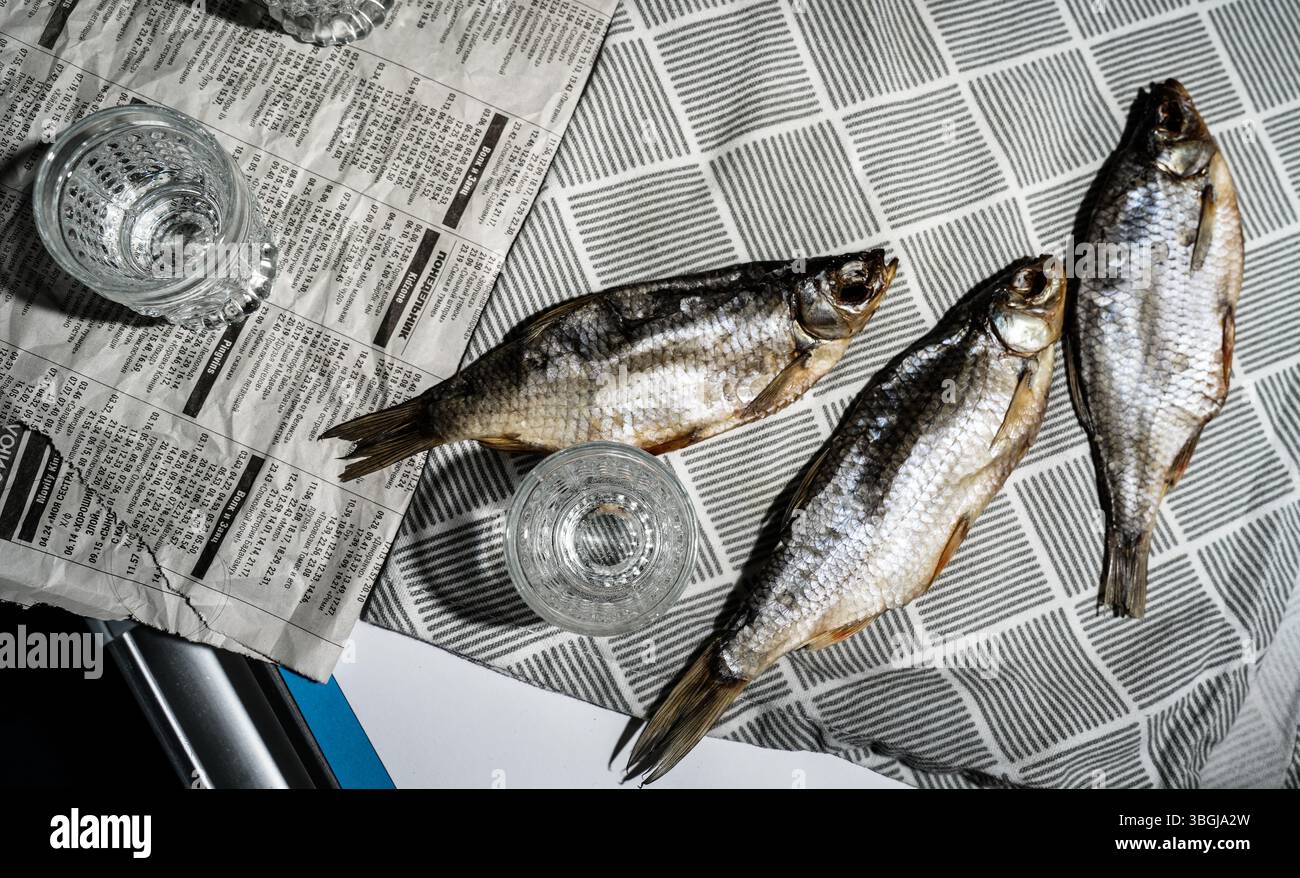 Vodka Glasses on Table with Dried Fish – Traditional Russian Snack Stock Photo