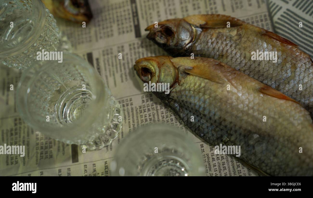 Vodka Glasses on Table with Dried Fish – Traditional Russian Snack Stock Photo