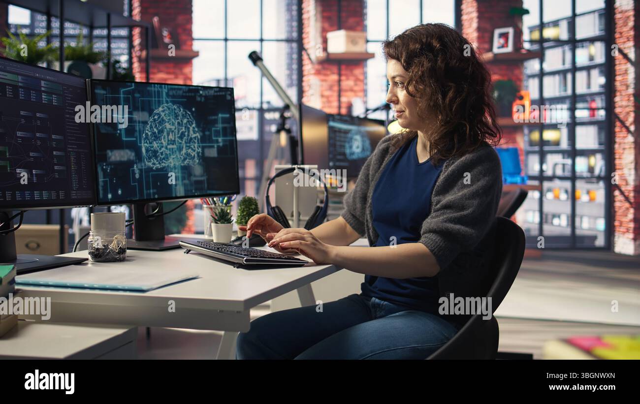 Teleworking developer using computer for artificial intelligence computing through self learning algorithms. Agency IT engineer works with AI deep neural networks on desktop PC. Camera A. Stock Photo