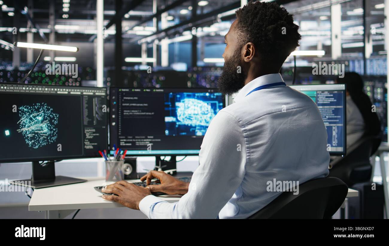 Server hub engineering team interprets AI generated data analytics graphs. Teamworking data center colleagues using artificial intelligence program showing predictive system metrics, camera A Stock Photo
