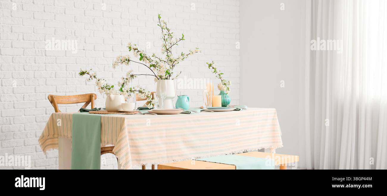 Elegant table setting with blooming tree branches Stock Photo