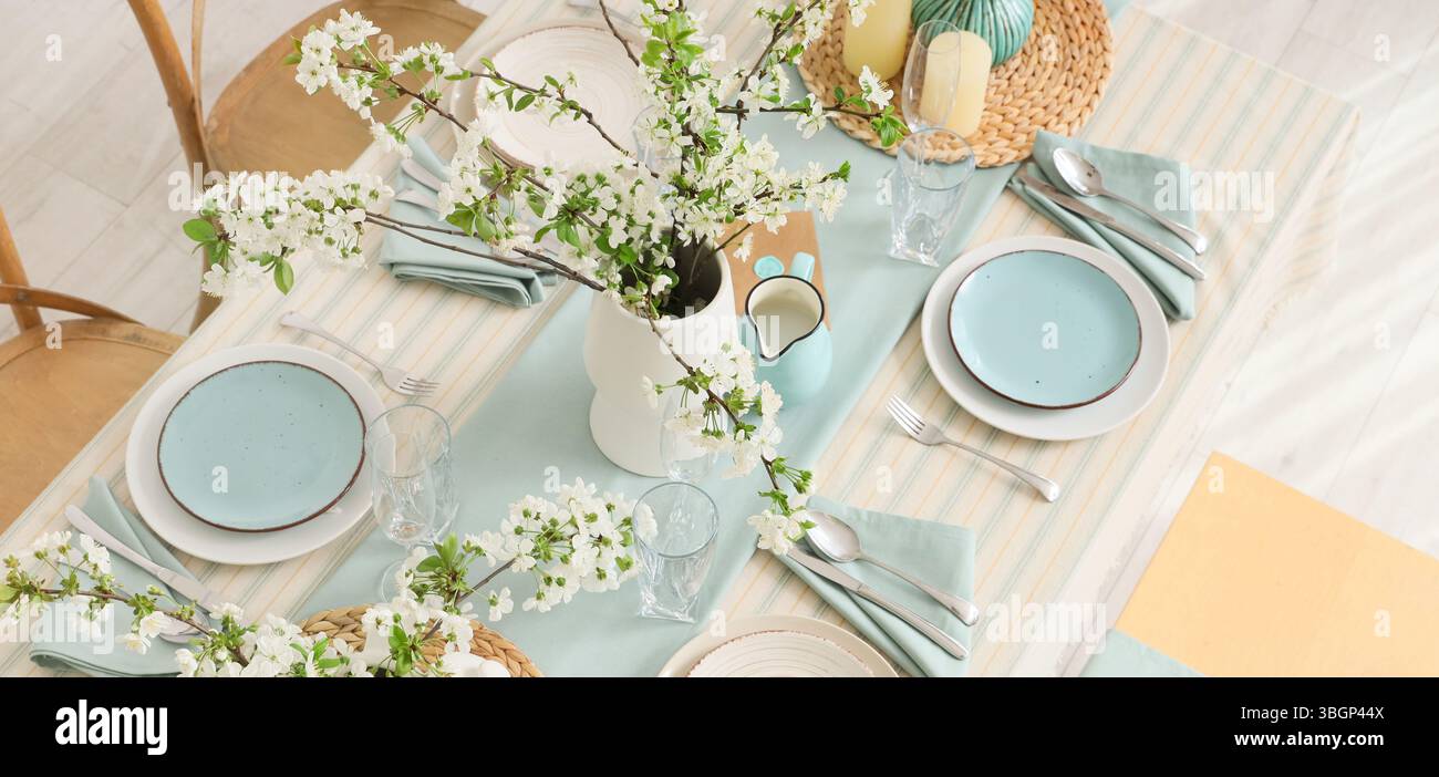 Elegant table setting with blooming tree branches Stock Photo