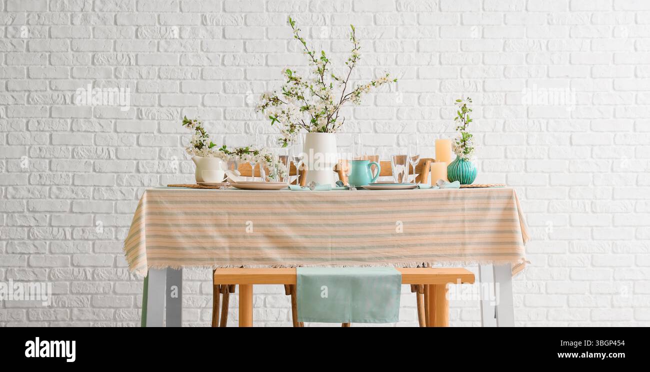 Elegant table setting with blooming tree branches Stock Photo