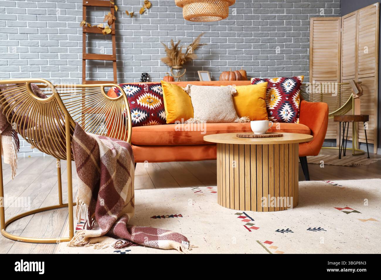 Interior of stylish living room with orange sofa, modern armchair and ...