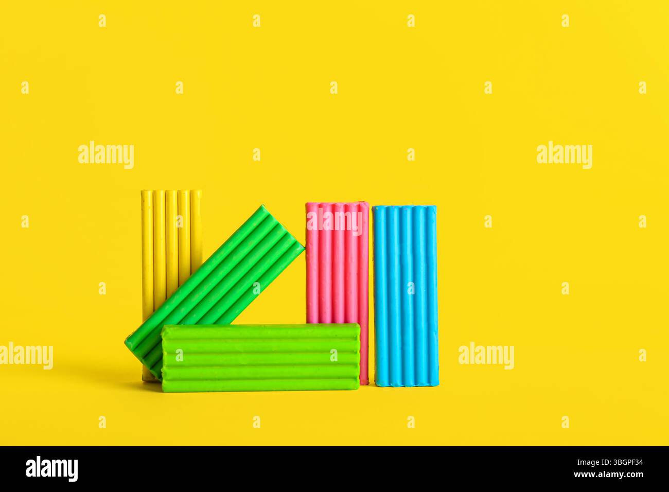 Colorful plasticine on yellow background Stock Photo