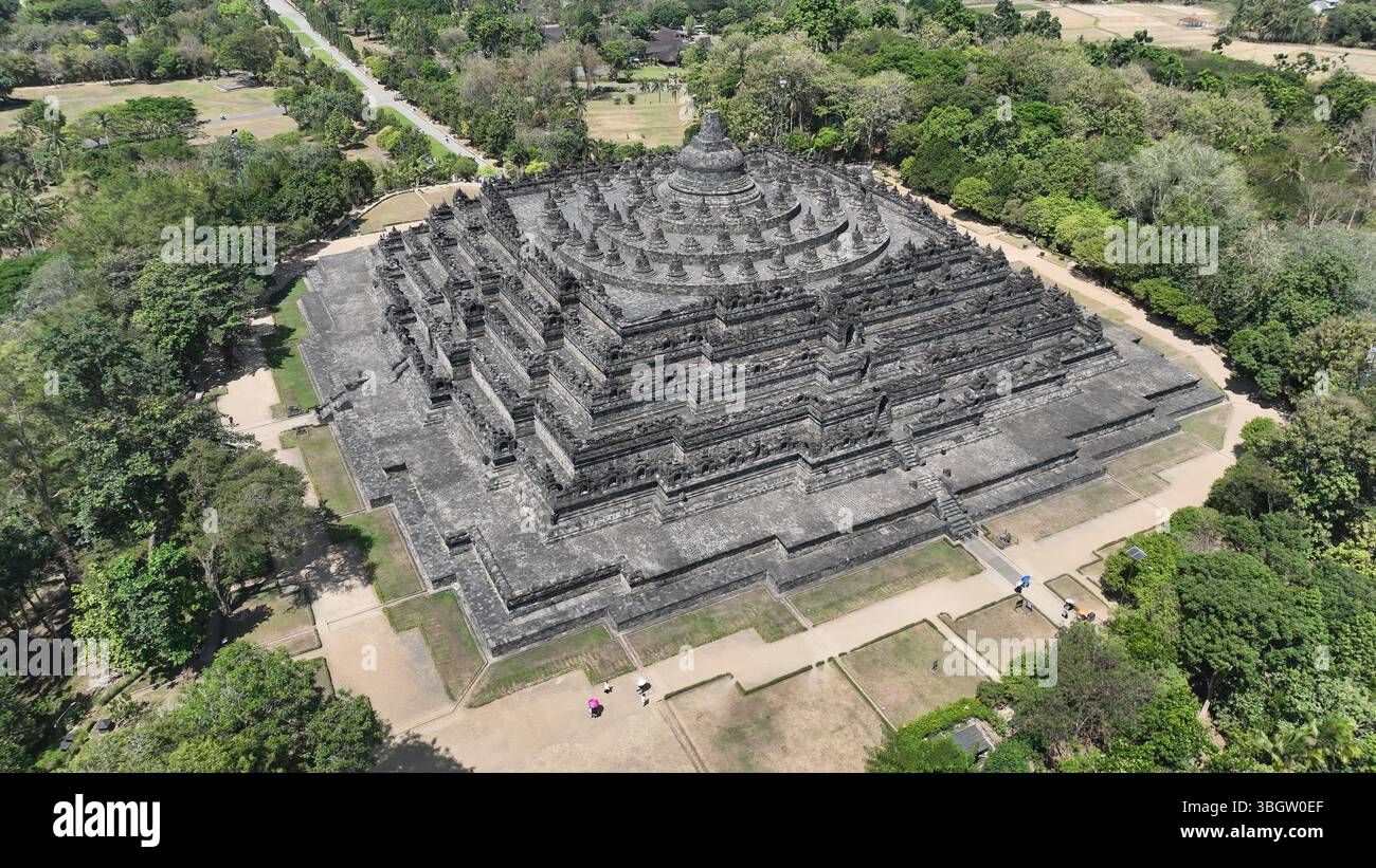 The geometric perfection of Borobudur is captured in this drone shot, highlighting the temples massive stone structure and the harmony between sacred Stock Photo