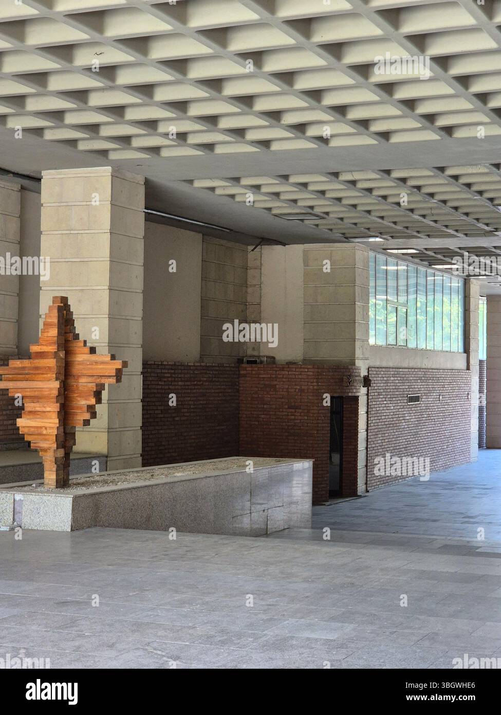 Entrance to a building built in the 80s. unusual ceiling and wooden installation - Smartphone Captured Stock Image