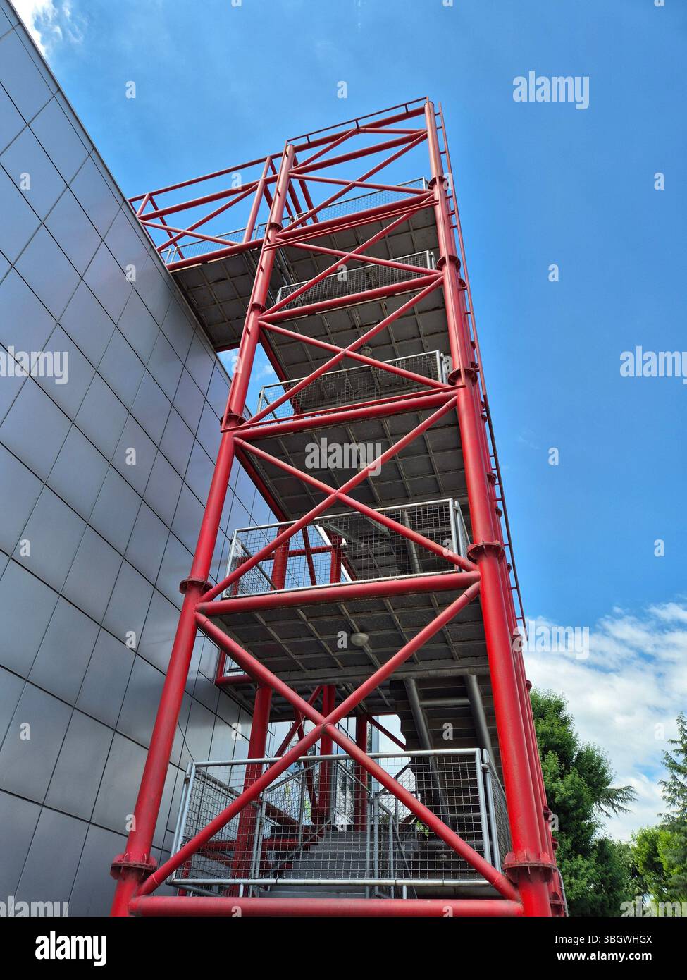 Industrial steel installation, giant red staircase. modern buildings - Smartphone Captured Stock Image
