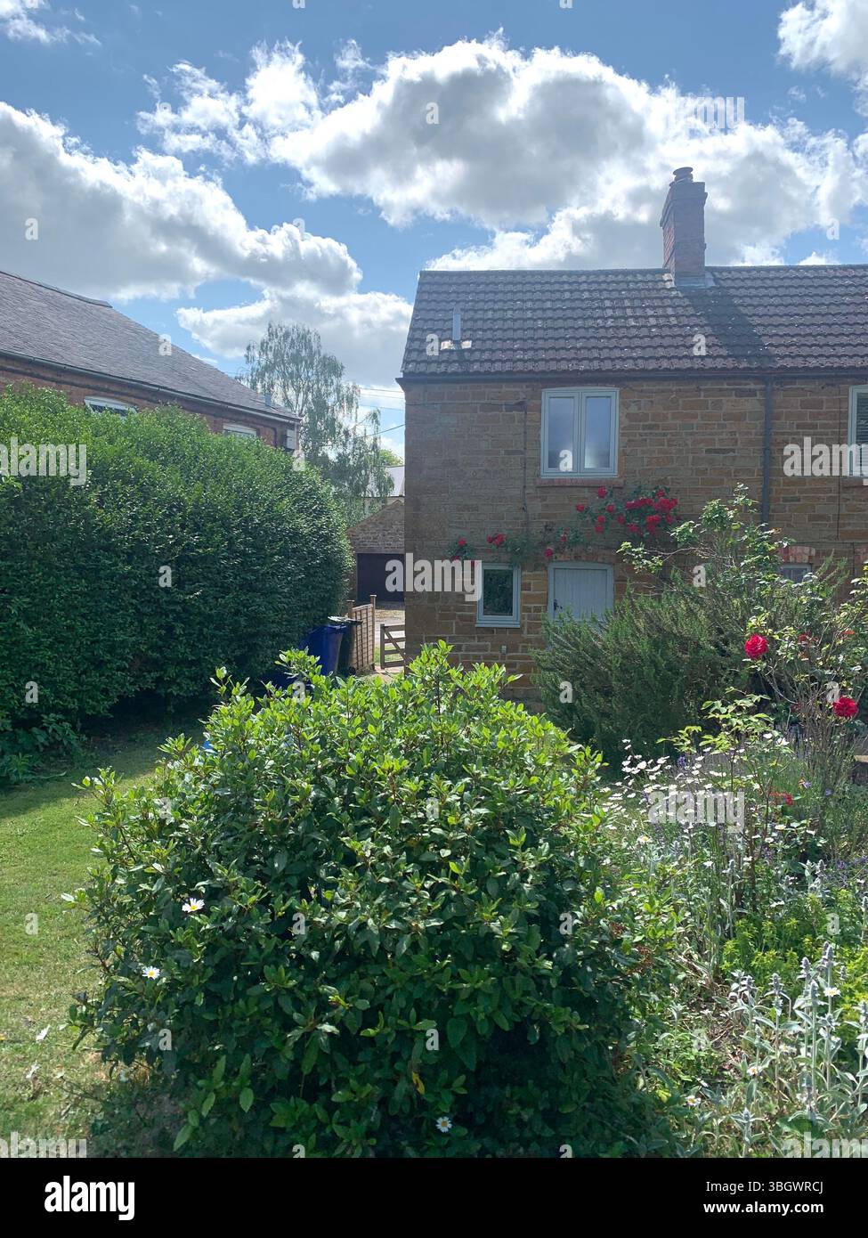 Cottage in Harpole Northampton Northamptonshire stone building small old history historic place building ancient residence Faulkner family home garden - Smartphone Captured Stock Image