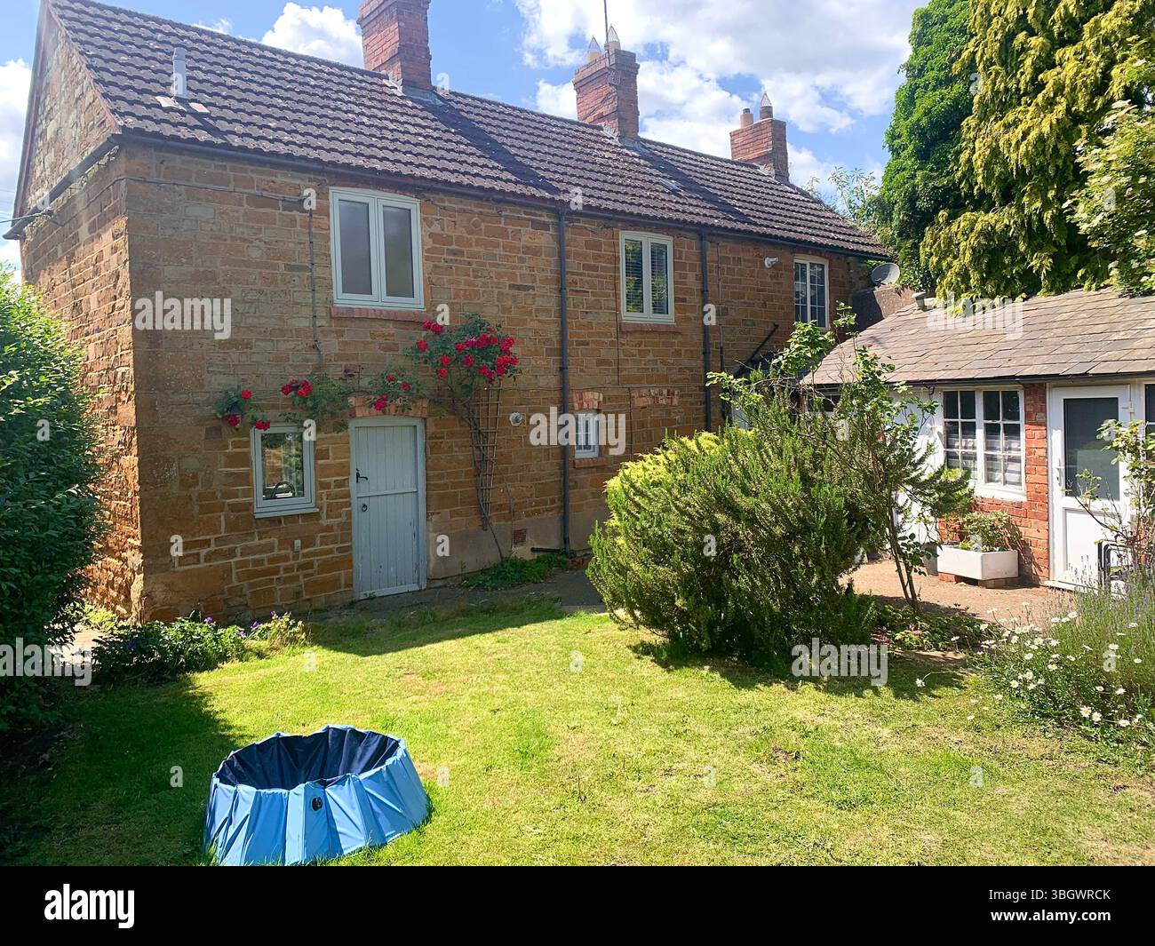 Cottage in Harpole Northampton Northamptonshire stone building small old history historic place building ancient residence Faulkner family home garden - Smartphone Captured Stock Image