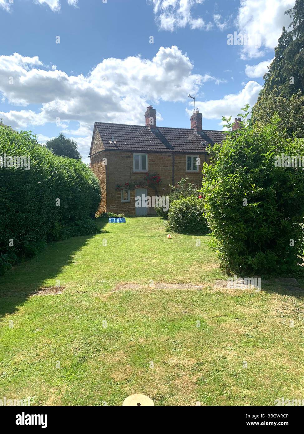 Cottage in Harpole Northampton Northamptonshire stone building small old history historic place building ancient residence Faulkner family home garden - Smartphone Captured Stock Image