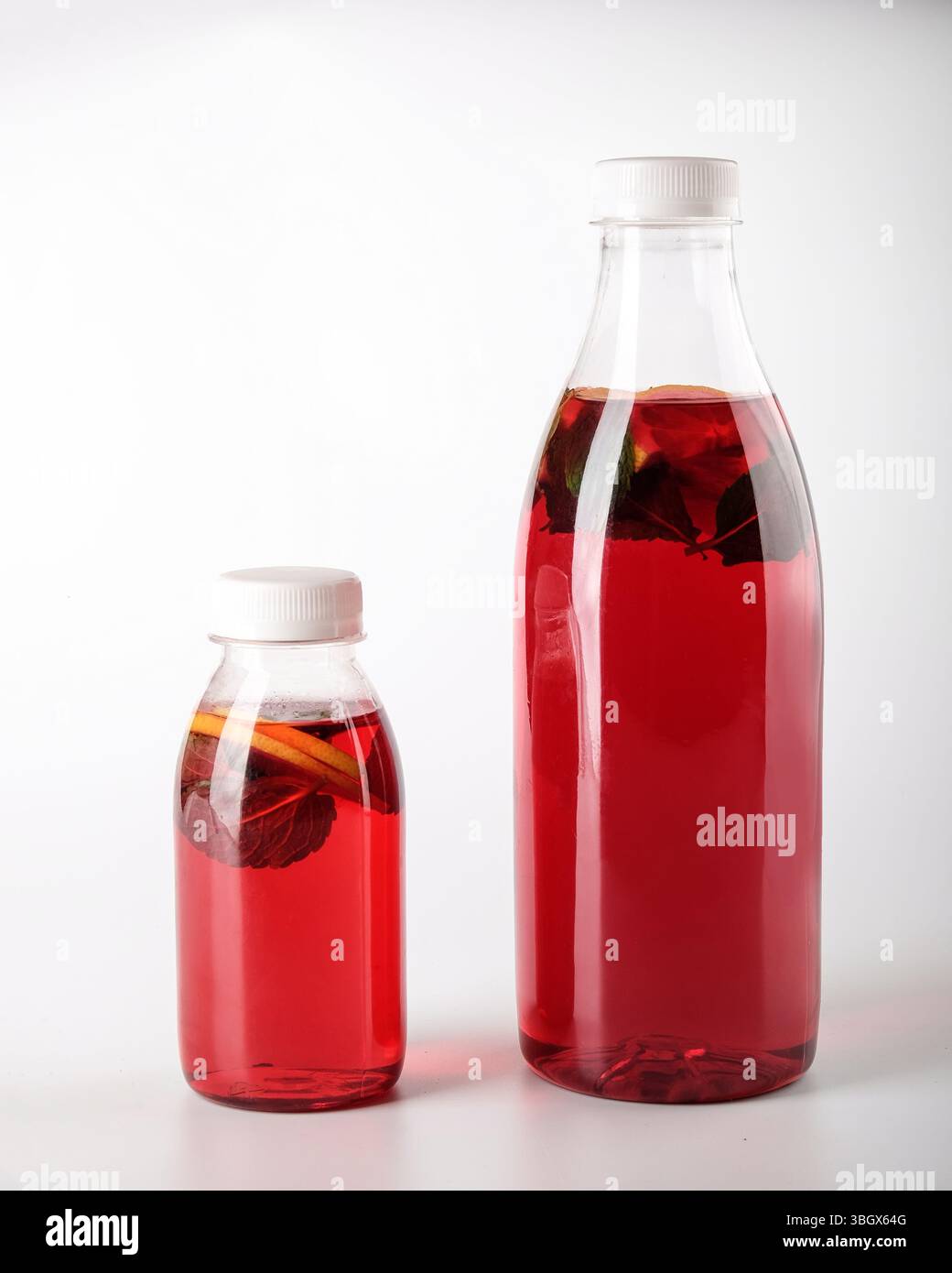 A collection of Vibrant Red Beverage Bottles elegantly arranged on a White Background Stock Photo