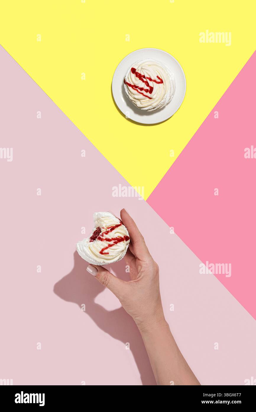 Enjoy these delicious cupcakes adorned with frosting on vibrant, colorful backgrounds Stock Photo