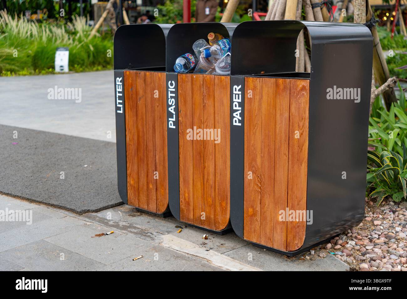 Bali, Indonesia - Dec 17, 2024: Black trash can with three bins for ...