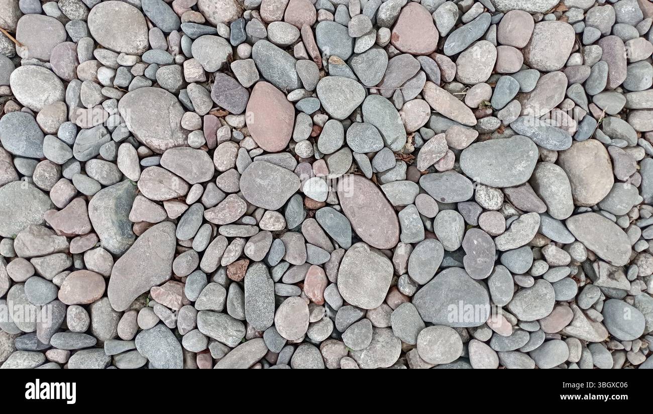 River pebbles with different textures close-up. Stone background Stock Photo