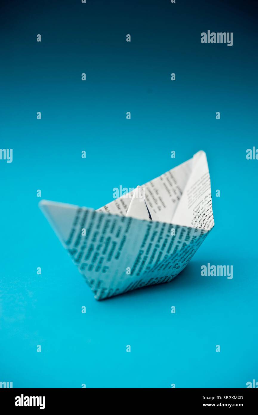 paper ship on blue background Stock Photo