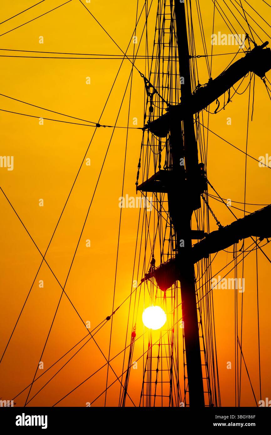 Silhouette of ship mast and ropes against golden sky Stock Photo - Alamy