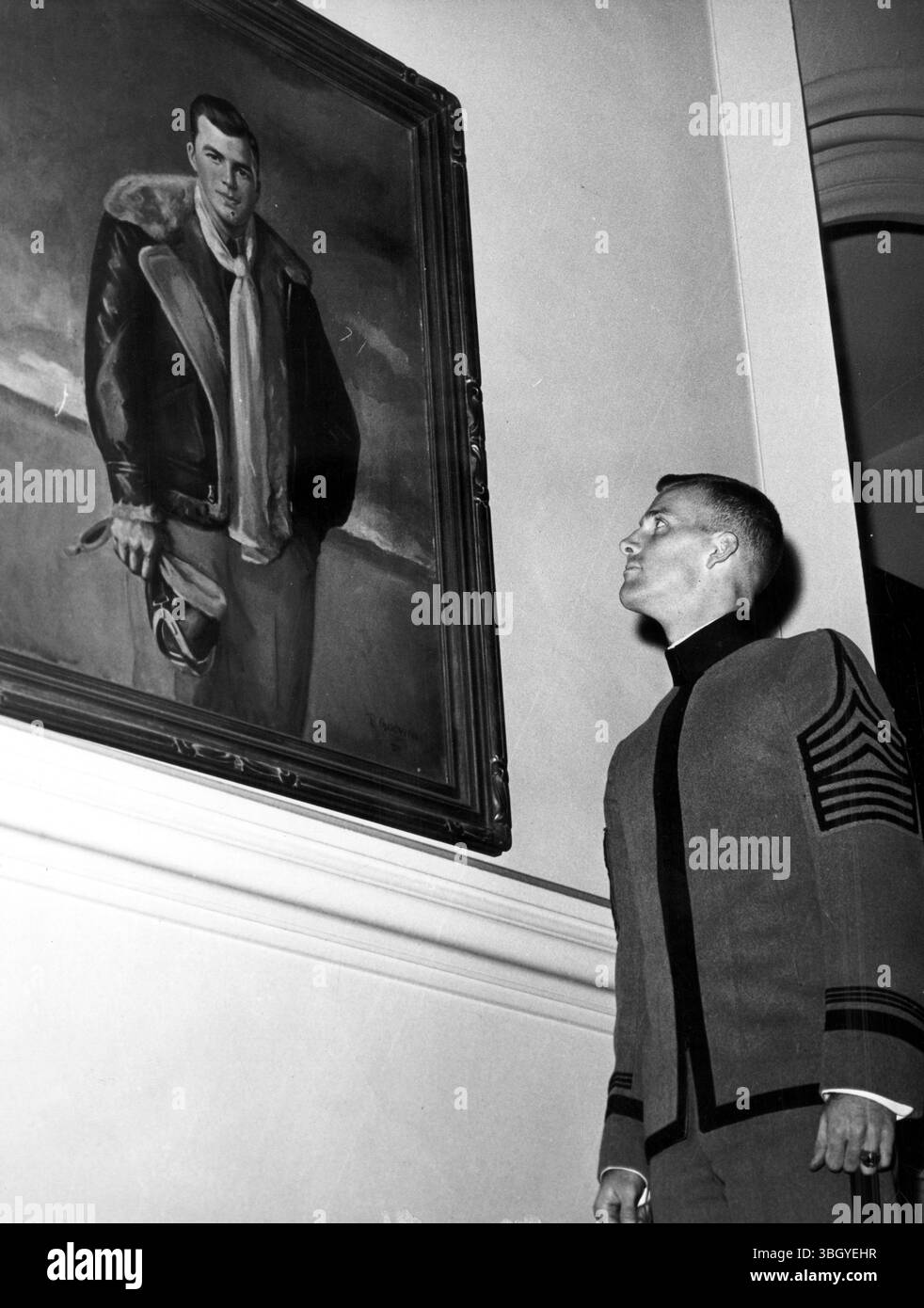 Westpoint Senior Colin P. Kelly III looked at a painting of his father, Captain Colin P. Kelly, Junior, In Westpoint's Church Hall. The older Kelly, was one of the 1st heroes of World War II, died 10th of December 1941 when he rammed his shot up B-17 bomber smokestack of the Japanese vessel which brought him down with anti-aircraft fire, off the coast of Luzon in the Philippines. 6 December 1962 Stock Photo