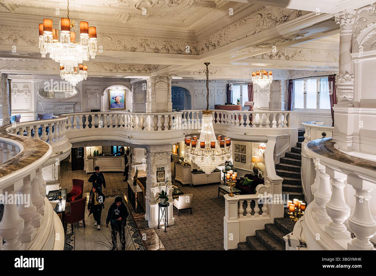 Elegant hotel lobby with chandeliers and grand staircase Stock Photo ...