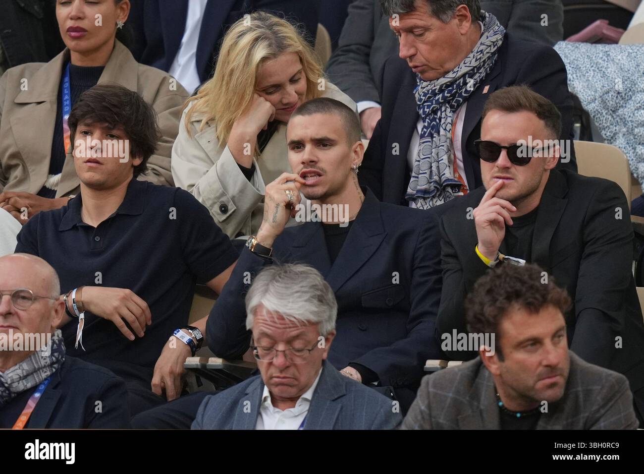 Romeo Beckham, centre, watches the semifinal match of the French Tennis ...