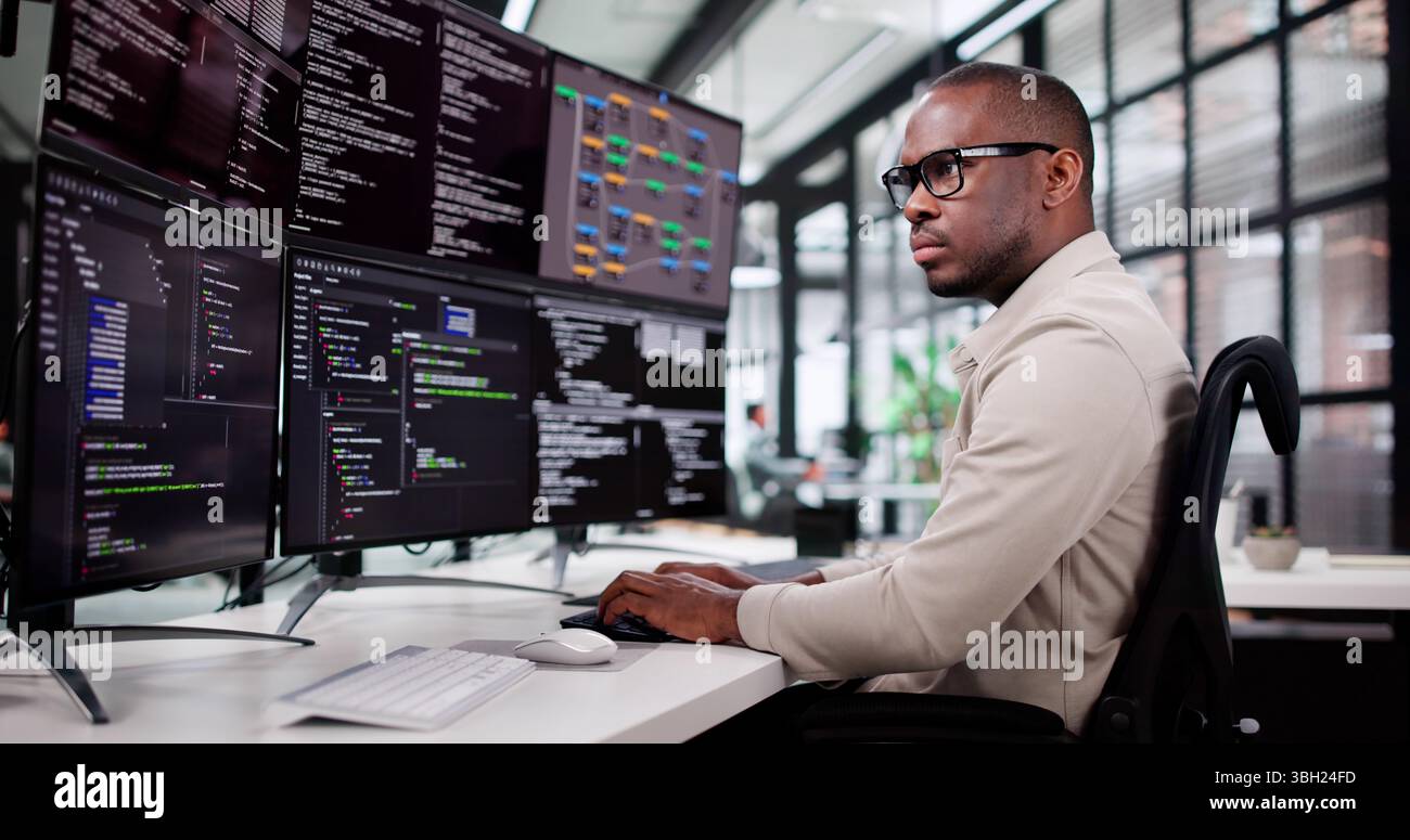 African American Programmer Developing Web Software In Office Setting Stock Photo