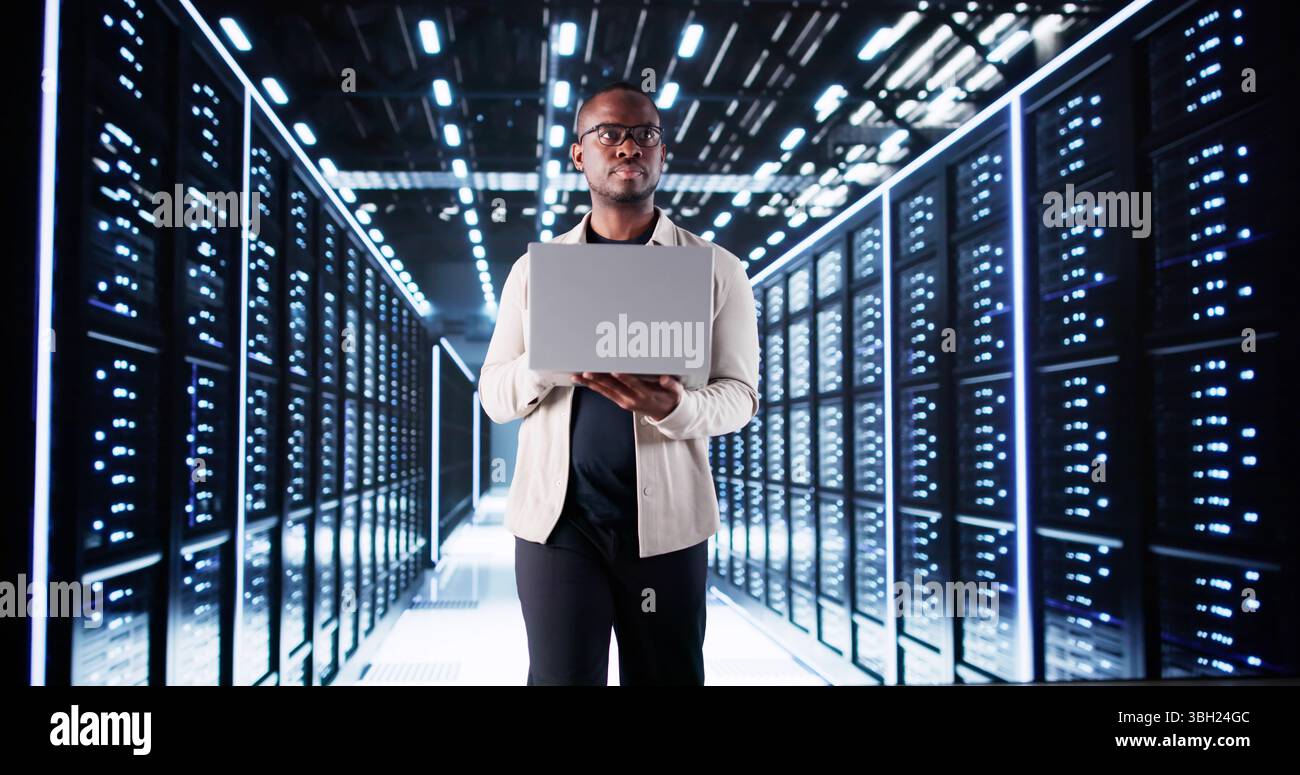 Smiling IT Specialist Configuring Servers In Data Center. Professional Engineer. Stock Photo