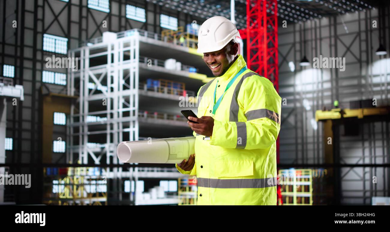 American Engineer Constructing Rocket Center With Smartphone And Blueprint In Hand Stock Photo