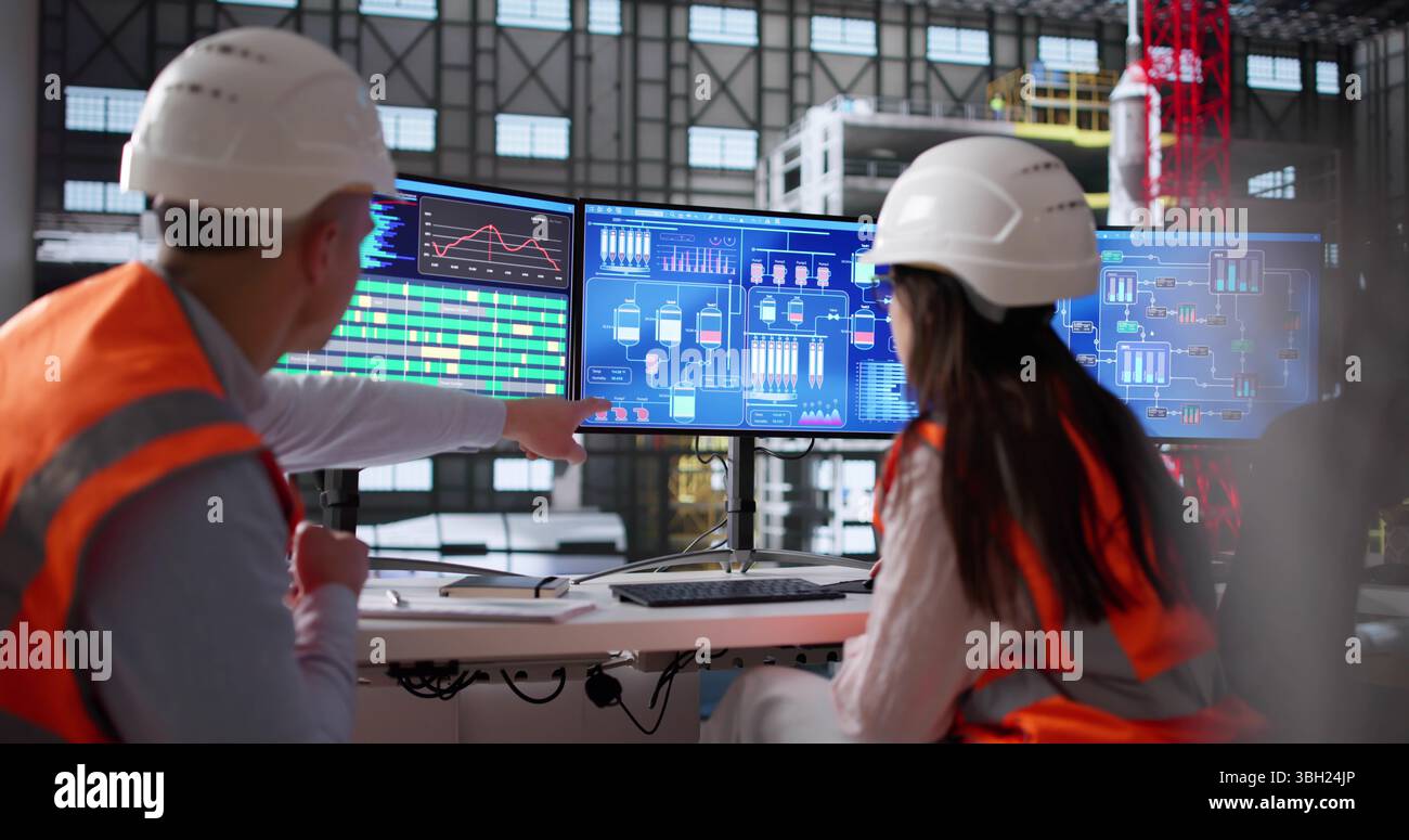 Young Engineer Operates Computer Program At Moon Exploration Agency Factory. Stock Photo