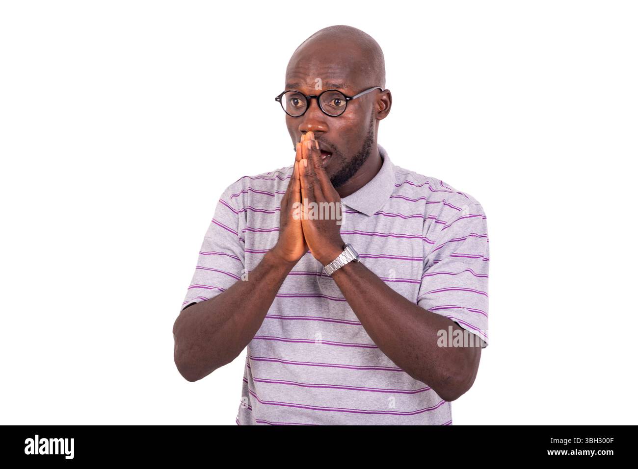young surprised business man with hands together while looking aside. Stock Photo