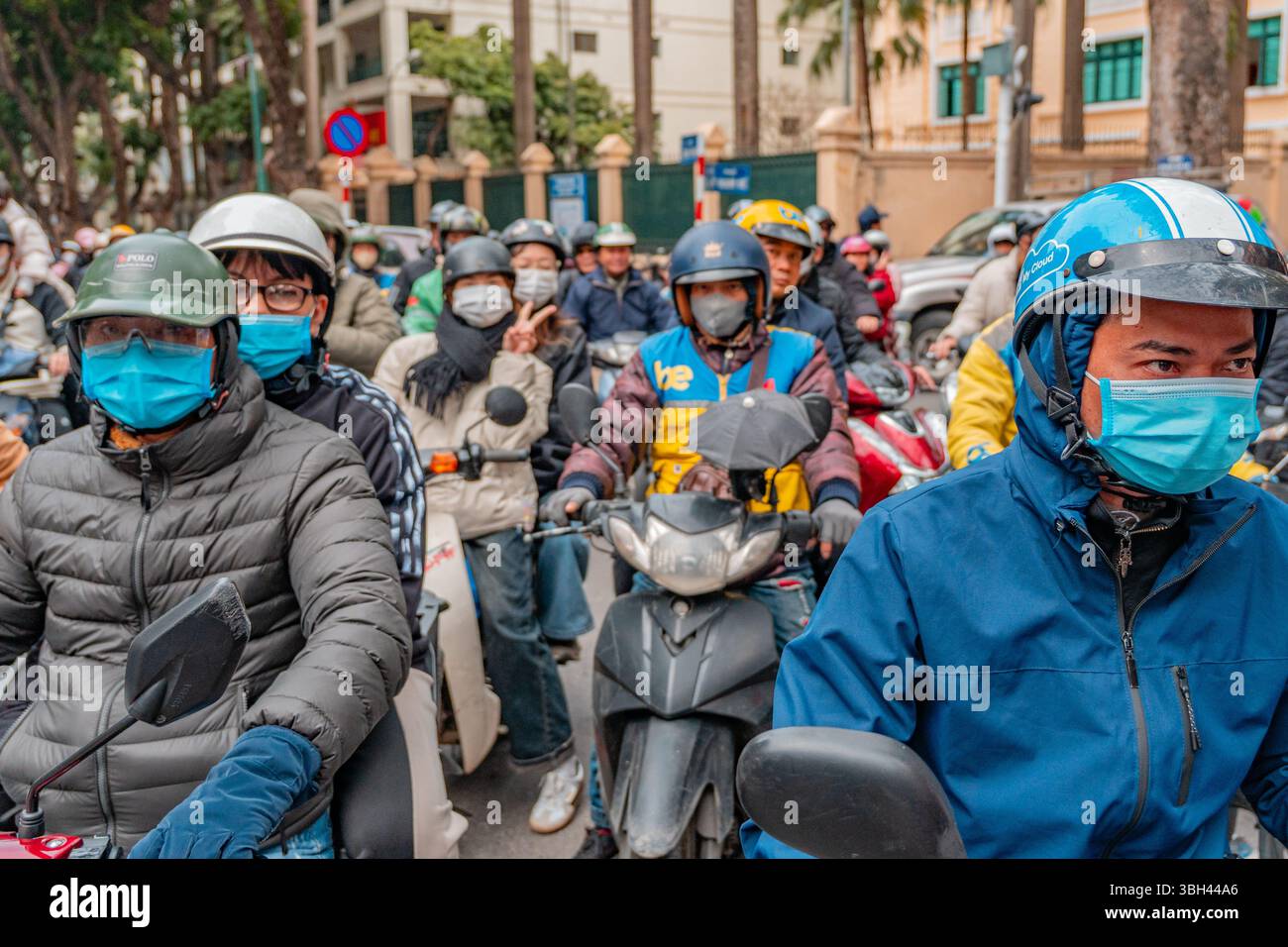 Hanoi, Vietnam- February 9, 2025: Crowd of people riding scooters on ...