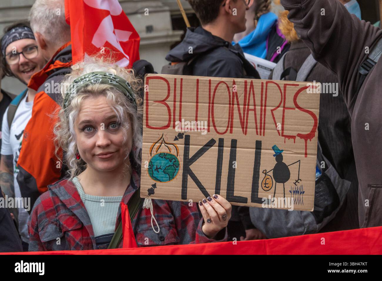London, UK. Billionaires Kill. Several thousand march from the BBC to Whitehall against the government spending more on arms while cutting public services, the NHS and benefits for the disabled - they say is a blueprint for arms manufacturers to print money based on a false narrative. They demand Welfare not Warfare and call for taxes on the rich, cutting down tax avoidance and evasion and an end to cuts. Peter Marshall/Alamy Live News Stock Photo