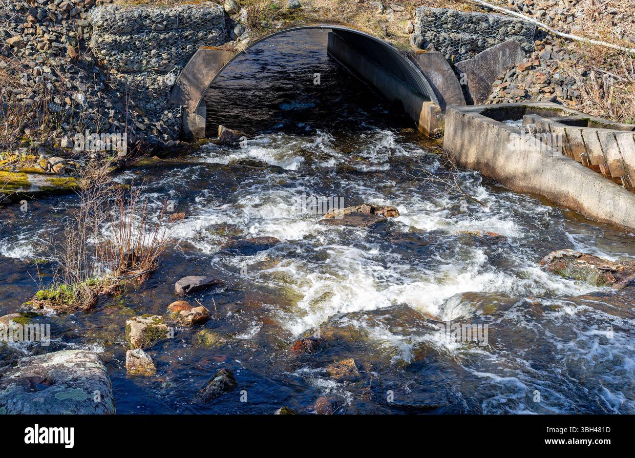 Water flowing under a large culvert in the spring in Maine Stock Photo ...
