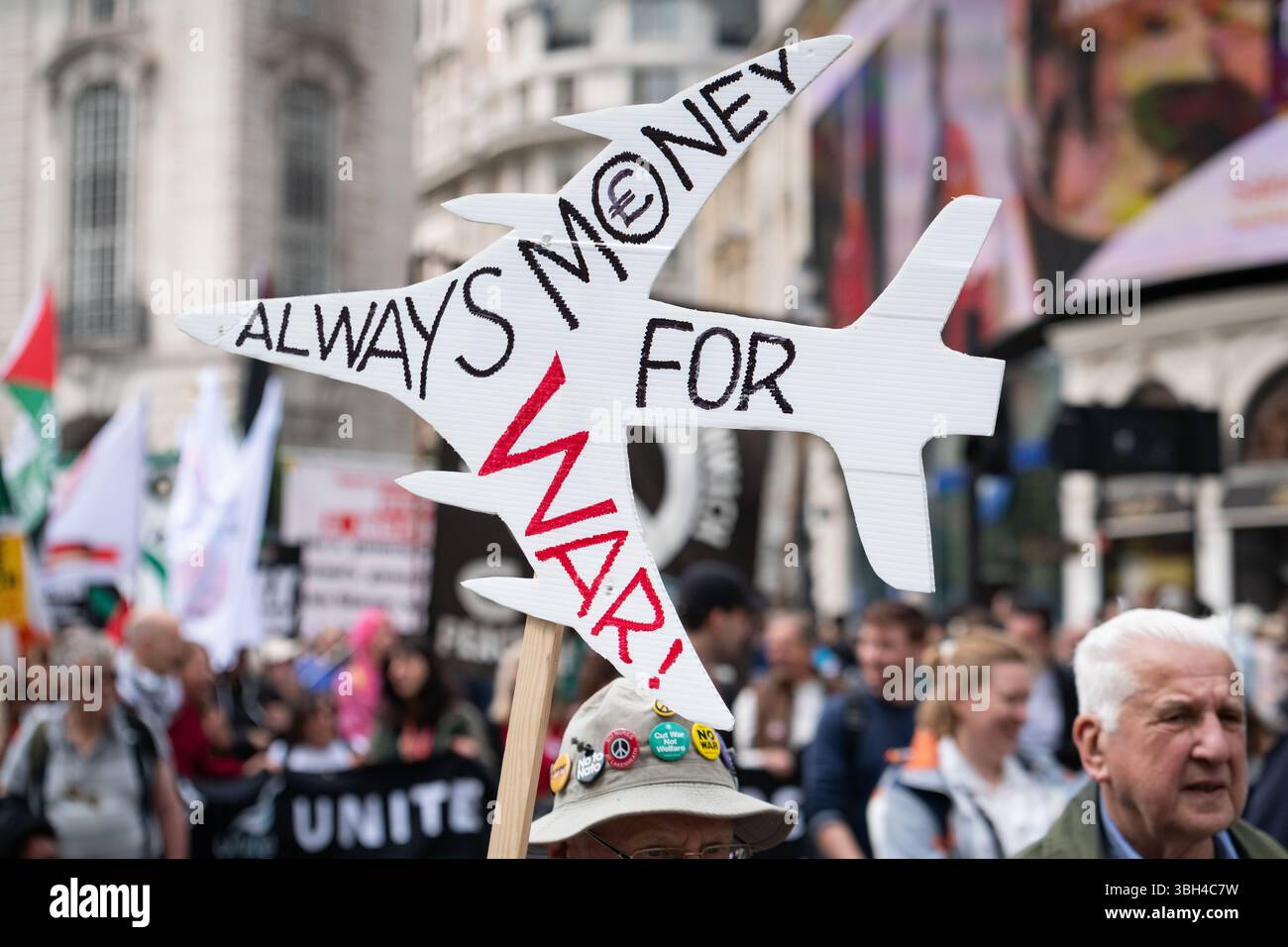 a crowd of people holding signs and flags in a protest against money for war