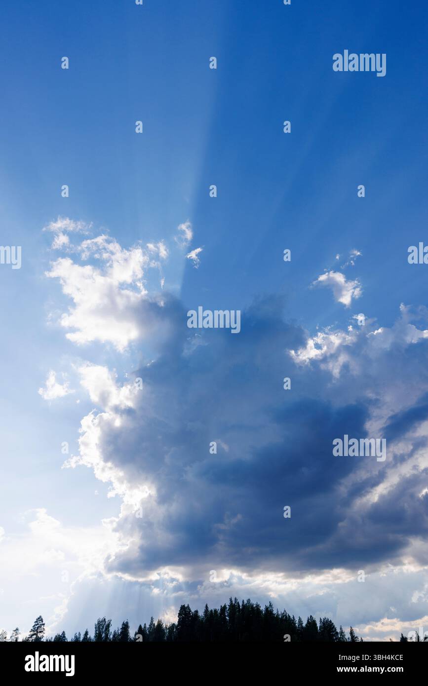 Sun glowing behind a dark cloud, Finland Stock Photo