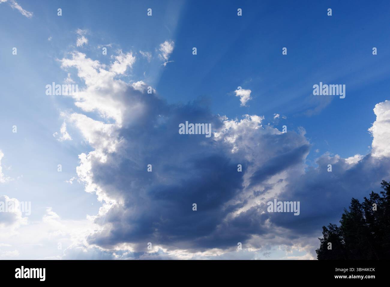 Sun glowing behind a dark cloud, Finland Stock Photo
