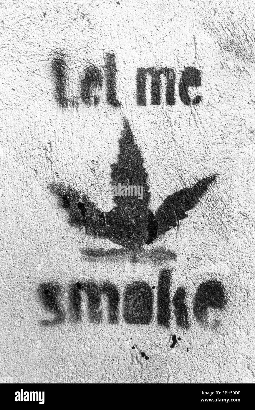 Let me smoke message with Marijuana leaf symbol on the wall. Ideal for your creative artwork Stock Photo