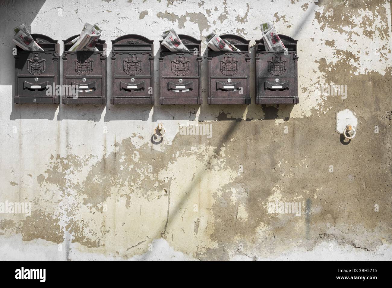 Old mailboxes hanging on the wall Stock Photo