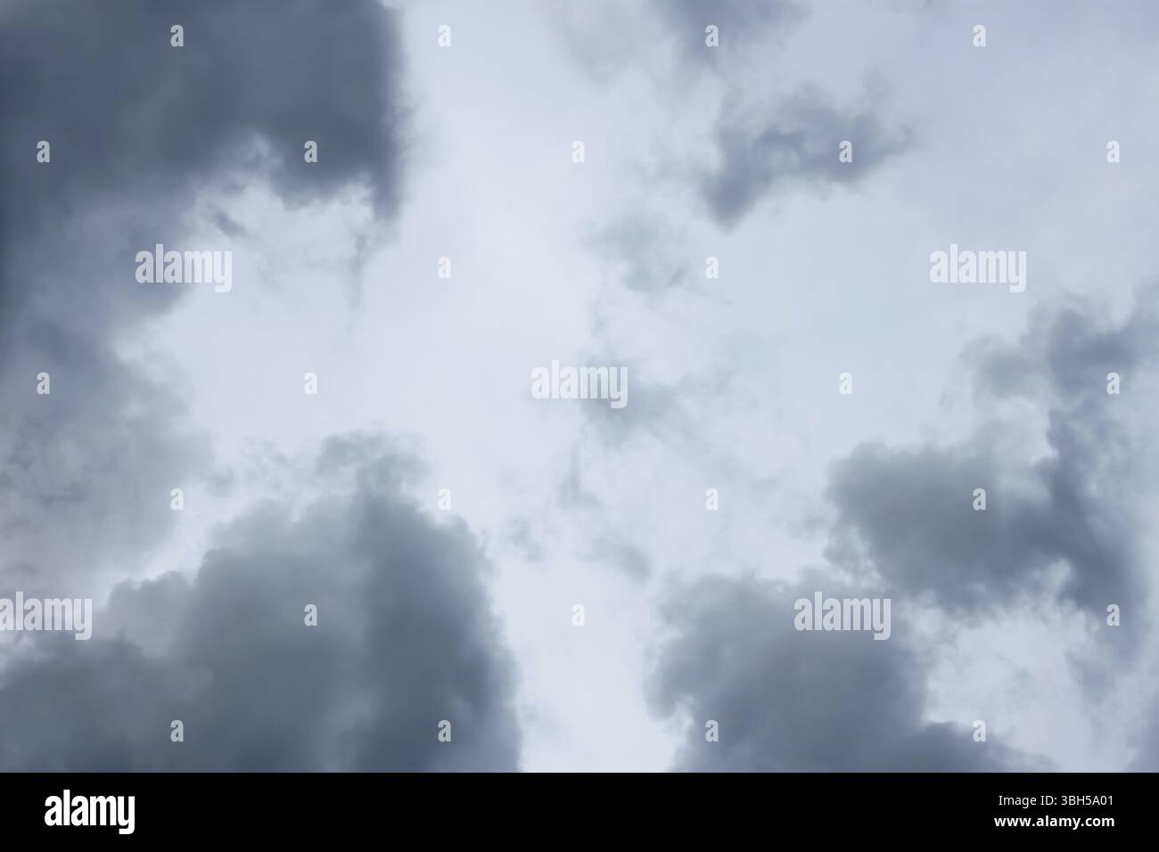 Grey and bluish tragic cloudscape with various density chaotic clouds Stock Photo