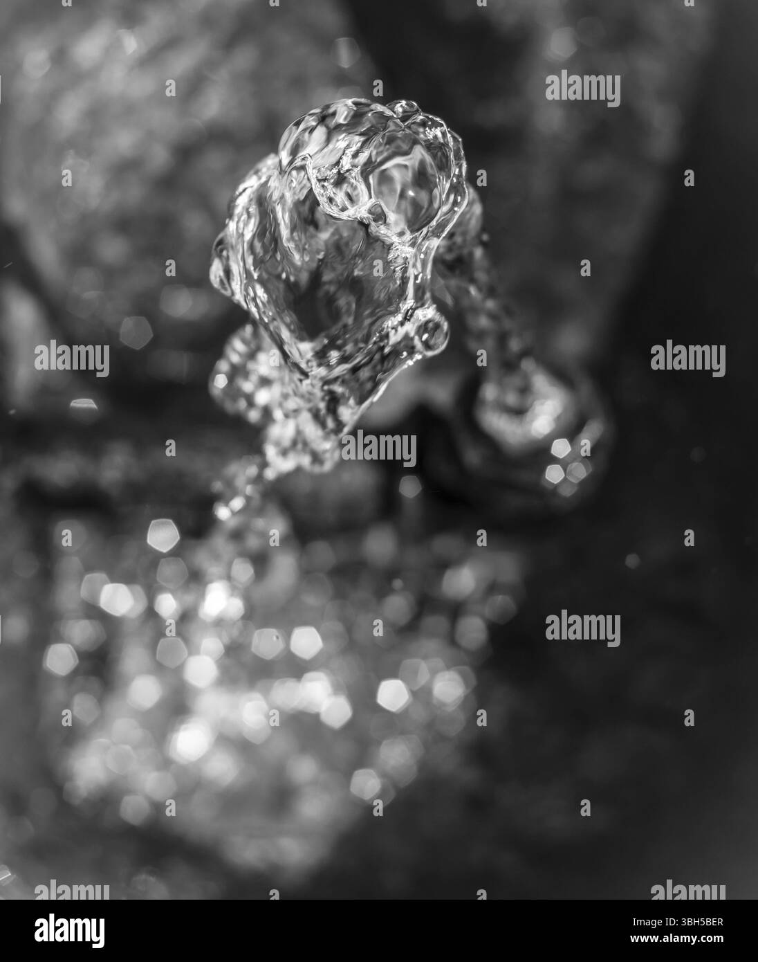 Water to drink in a vintage fountain, extreme closeup. Top view. Defocused blurry background Stock Photo