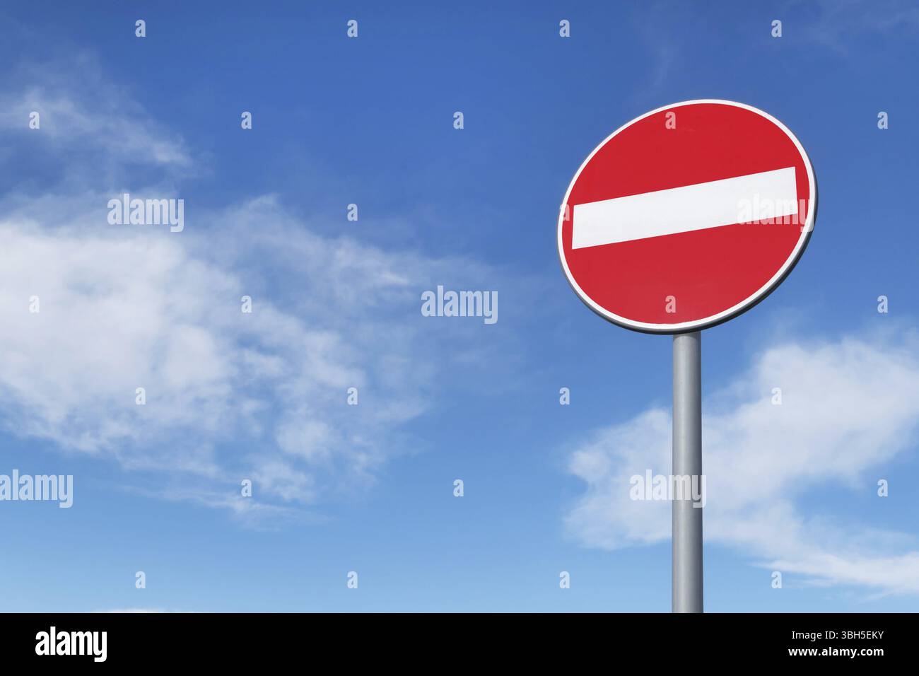 No entry for vehicular traffic. Road sign against blue sky. Space for ...