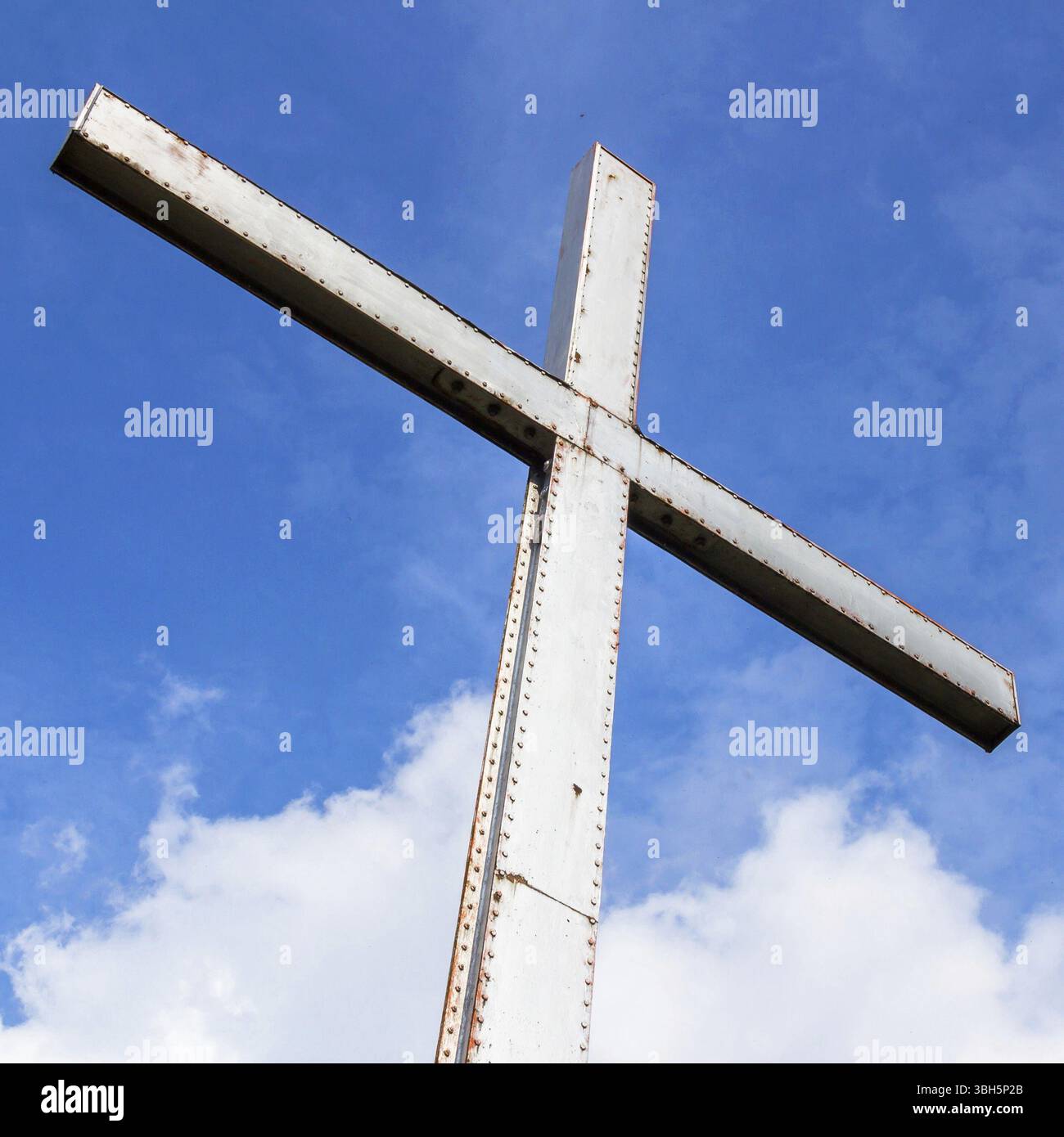 Iron cross over a blue sky with clouds background. Universal symbol of ...