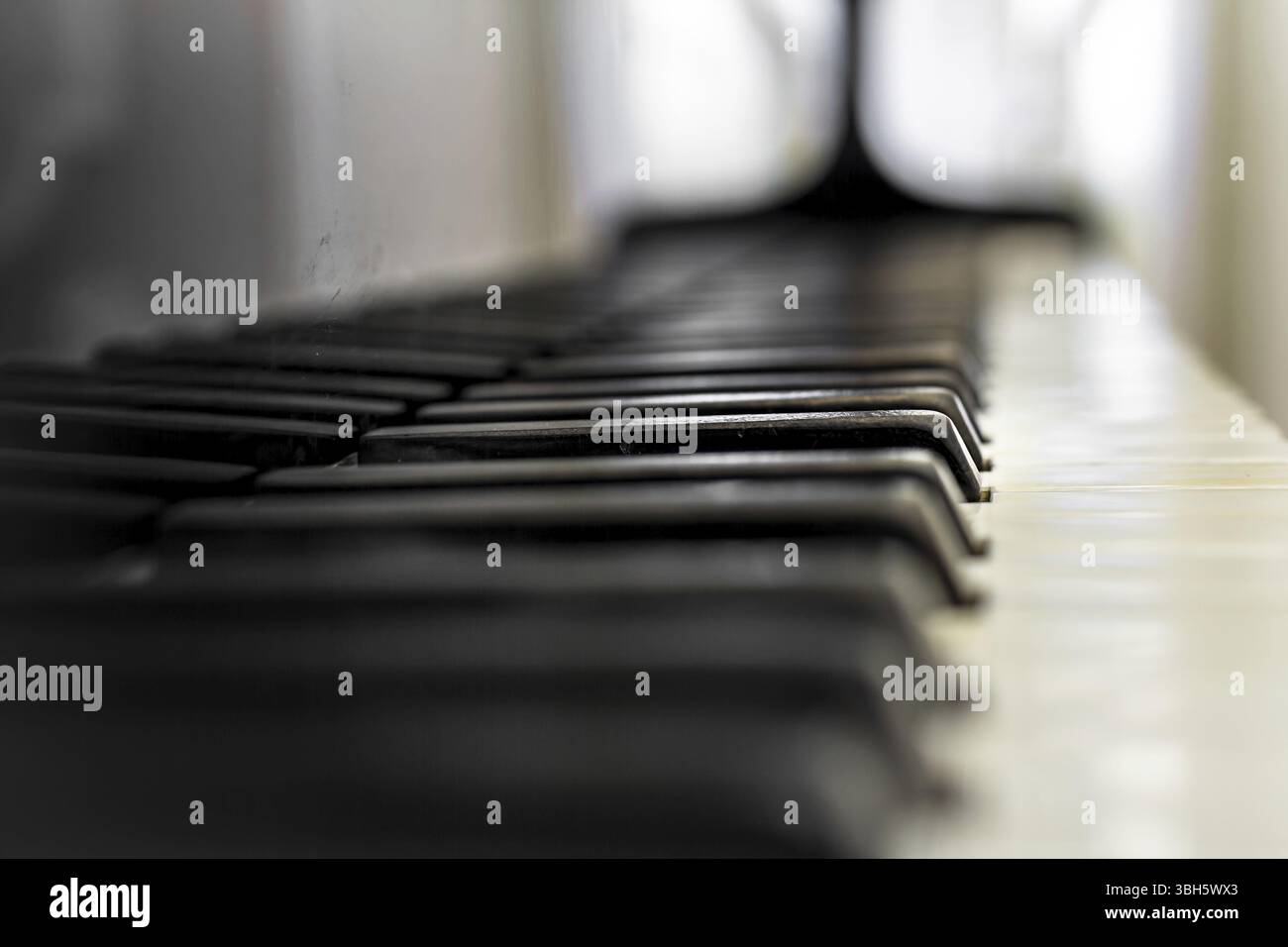 Old Piano keyboard with selective focus, behind a blurred background Stock Photo