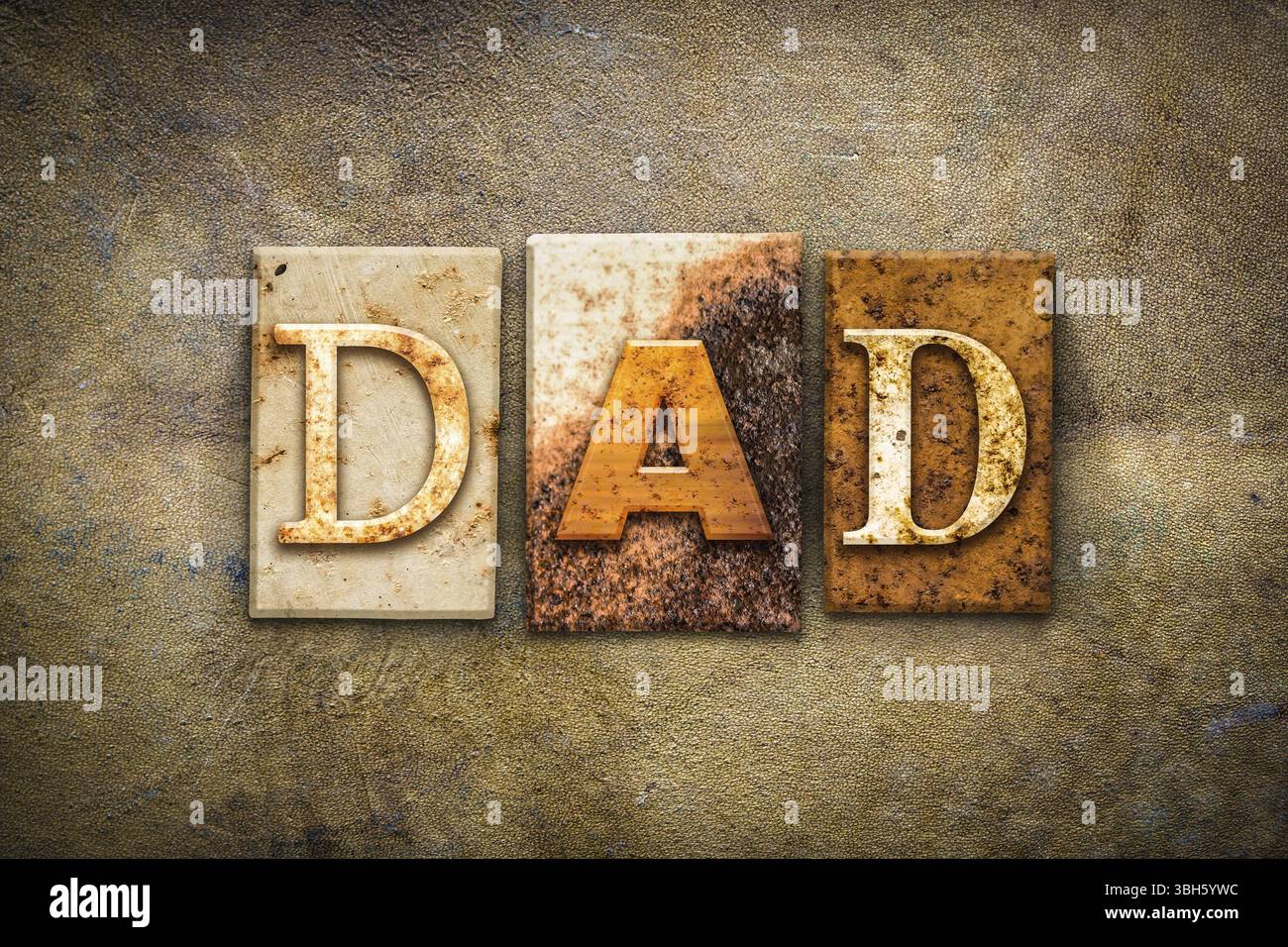 The word DAD written in rusty metal letterpress type on an old aged ...