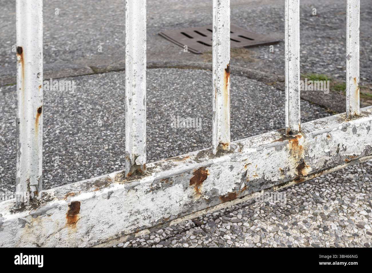 Rusty white gate on gray street background Stock Photo