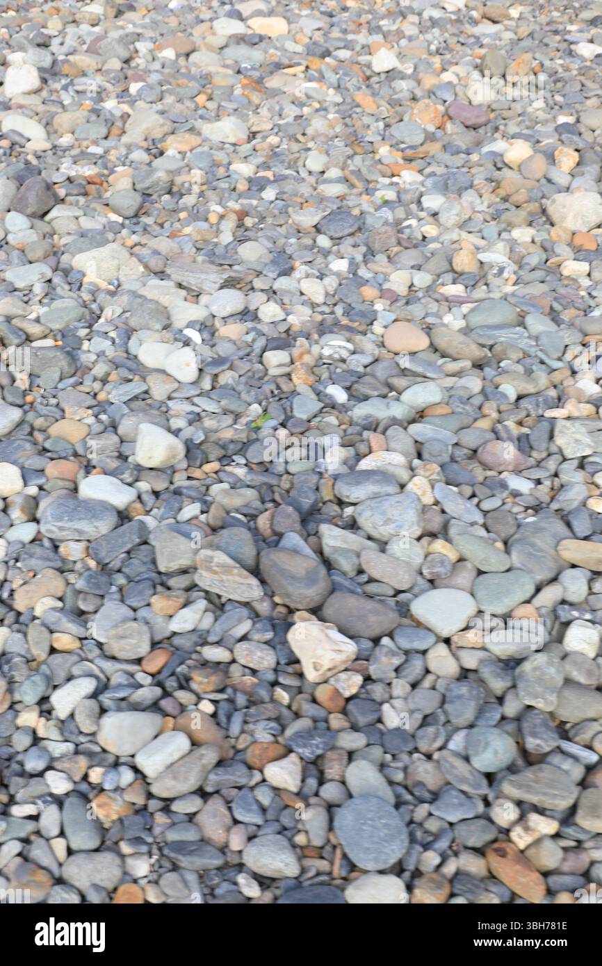 mooth pebbles background. variety of smooth, natural rocks with different shapes and textures Stock Photo
